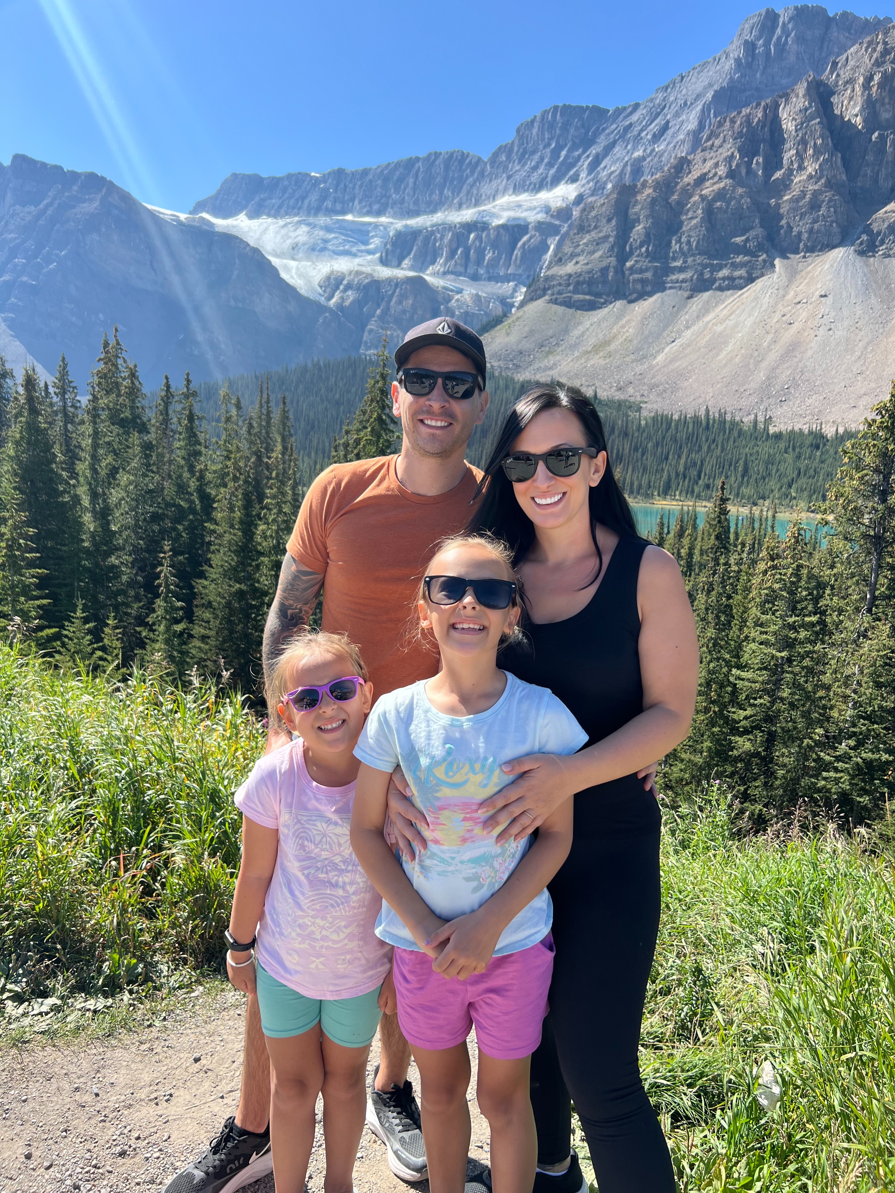 The Limitless Travel Family - Trevor, Tiffany, Keira, and Lucy in a beautiful mountain landscape
